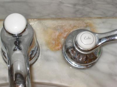 Brown stain on white marble vanity top