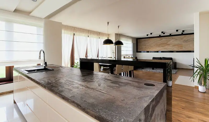 Dekton countertops color Trillium kitchen island white cabinets wood floor