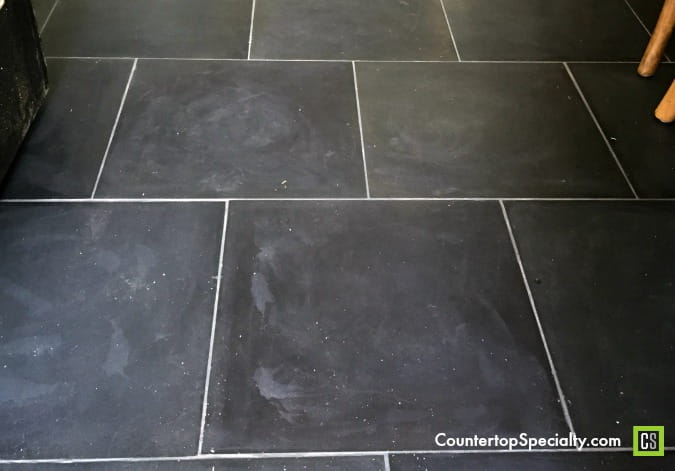 bleach damaged black marble floor - marble etching