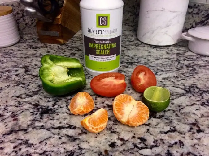 food-safe granite sealer bottle sitting on granite countertop surrounded by fruit and vegetables