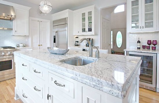 granite countertop color Bianco Romano on this kitchen island looks like Carrara marble