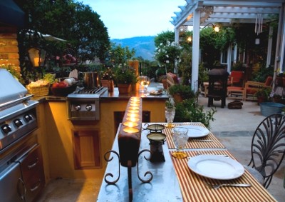 cozy outdoor kitchen with bartop and pergola