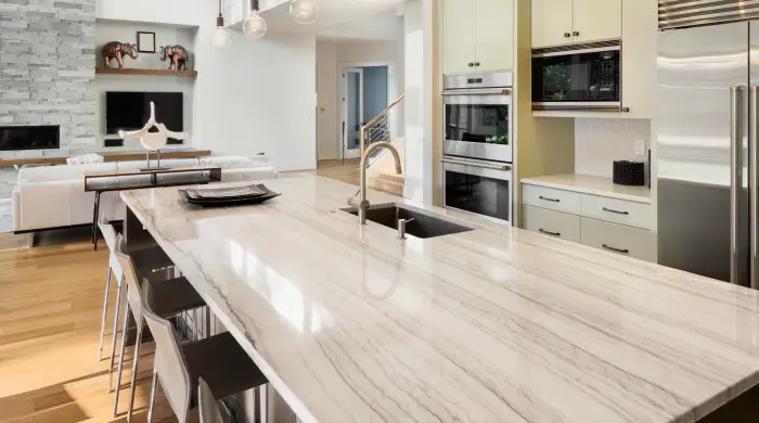 quartzite countertops white macaubus on long kitchen island in modern home