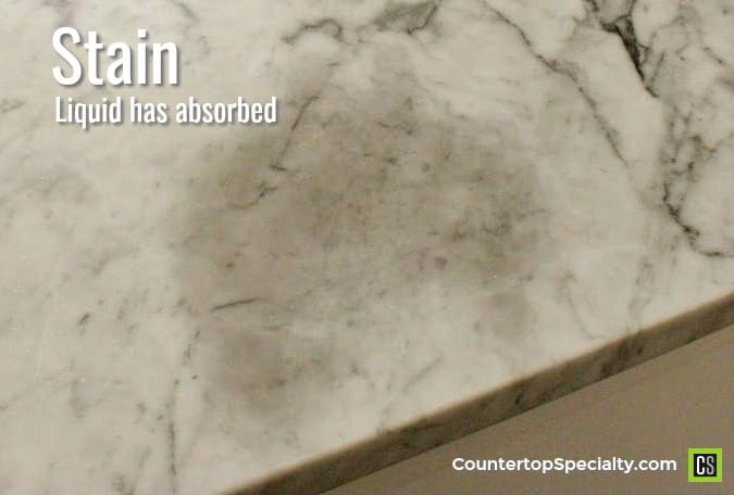 dark oil stain in marble countertop