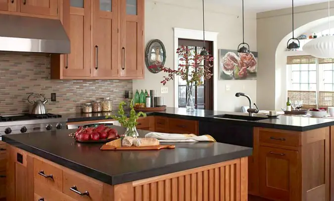 black concrete countertops on kitchen island with wood cabinets