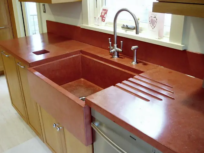 concrete countertops with custom red color and integrated sink and drainboard