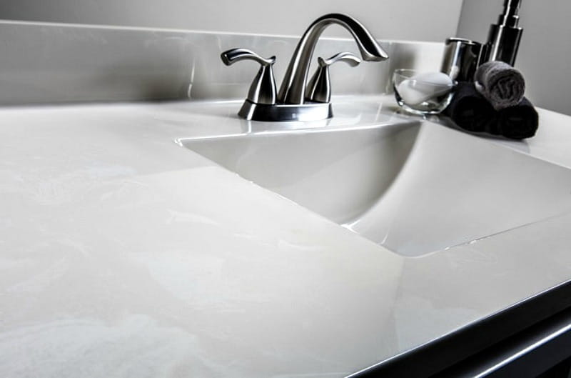 white cultured marble vanity with modern design and wave bowl sink