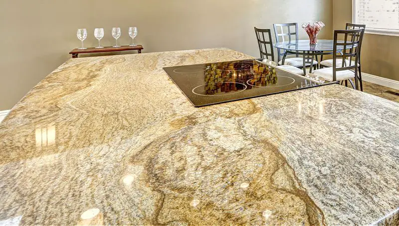 gold granite countertops with wavy pattern movement on kitchen island