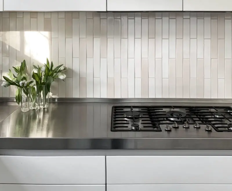 terracotta lava stone backsplash tiles over black kitchen countertops