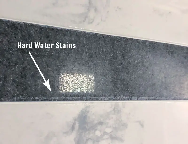 hard water stains on cultured marble shower wall