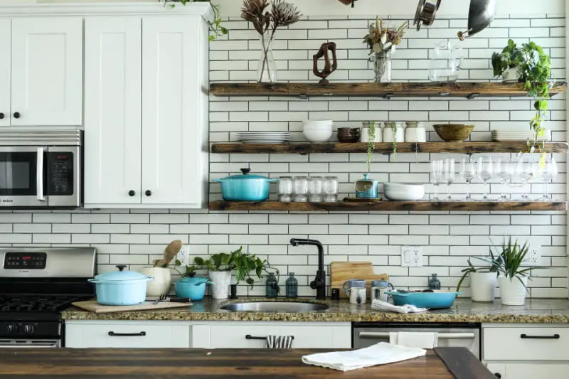 kitchen design ideas: open wood shelving on white subway tile backsplash