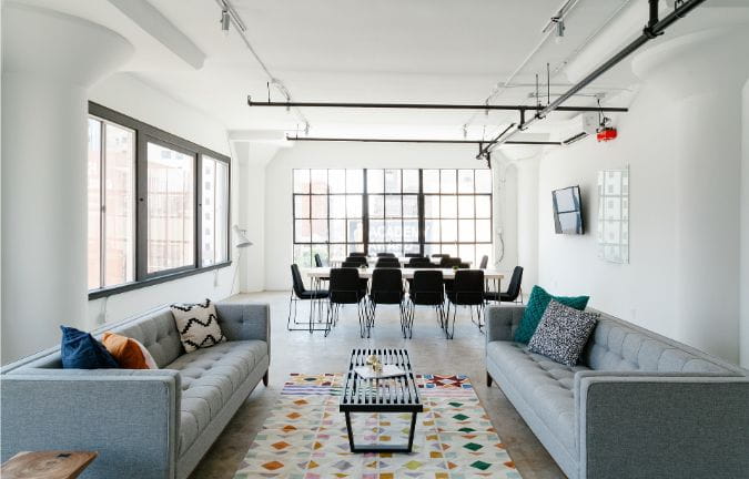 modern accent rug on floor between couches