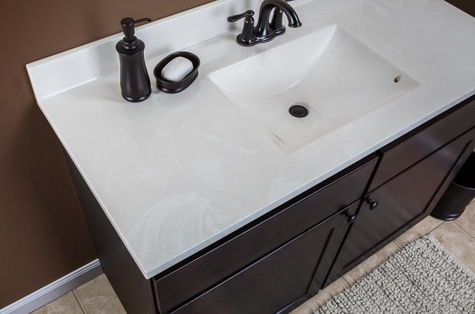 modern white cultured marble countertop with built-in sink and backsplash