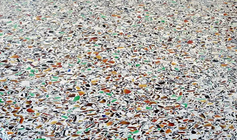 multicolored crushed glass countertop surface close up” title=