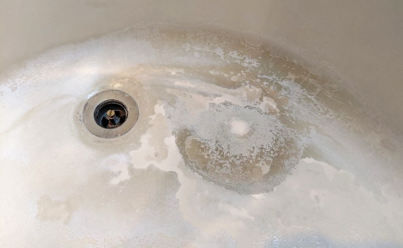 How to repair cultured marble tub damage around drain