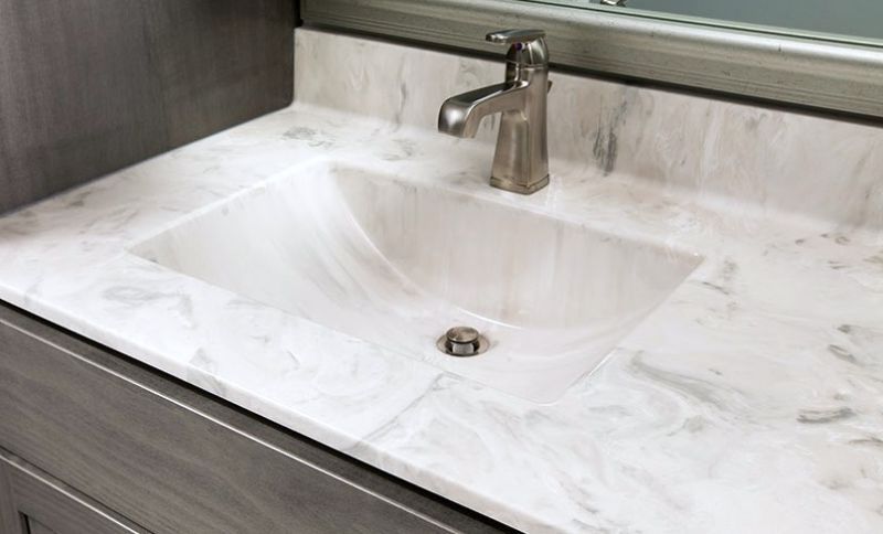 white cultured marble vanity top with integrated sink and backsplash.