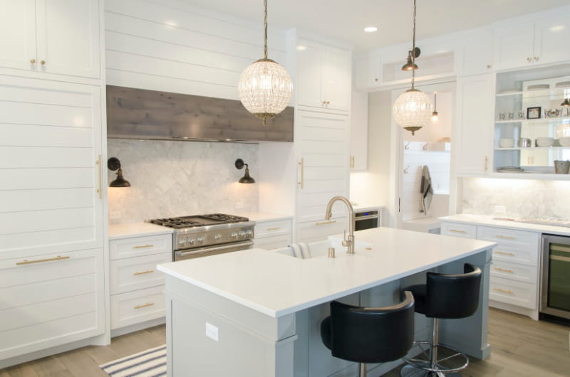 kitchen remodel - white quartz countertops, marble backsplash, white cabinets, kitchen island with stools
