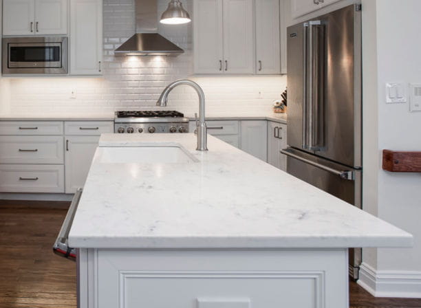 white marble countertops on an island in a modern kitchen design